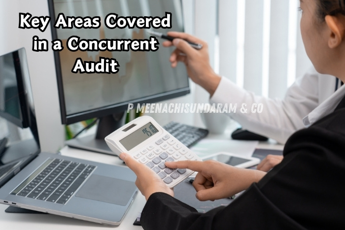 Financial data with a calculator and dual monitors during a concurrent audit - P Meenachisundaram & Co in Coimbatore